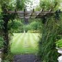 Weathered pergola with climbers