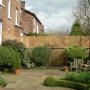 Trellis run along a wall to add some privacy to garden